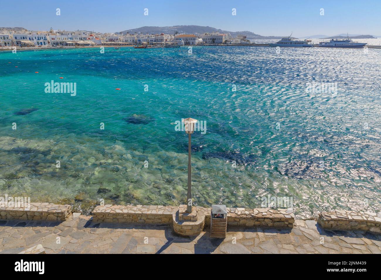 Panoramic view of the old port of Mykonos in Greece. Walkway on the marina. Stock Photo