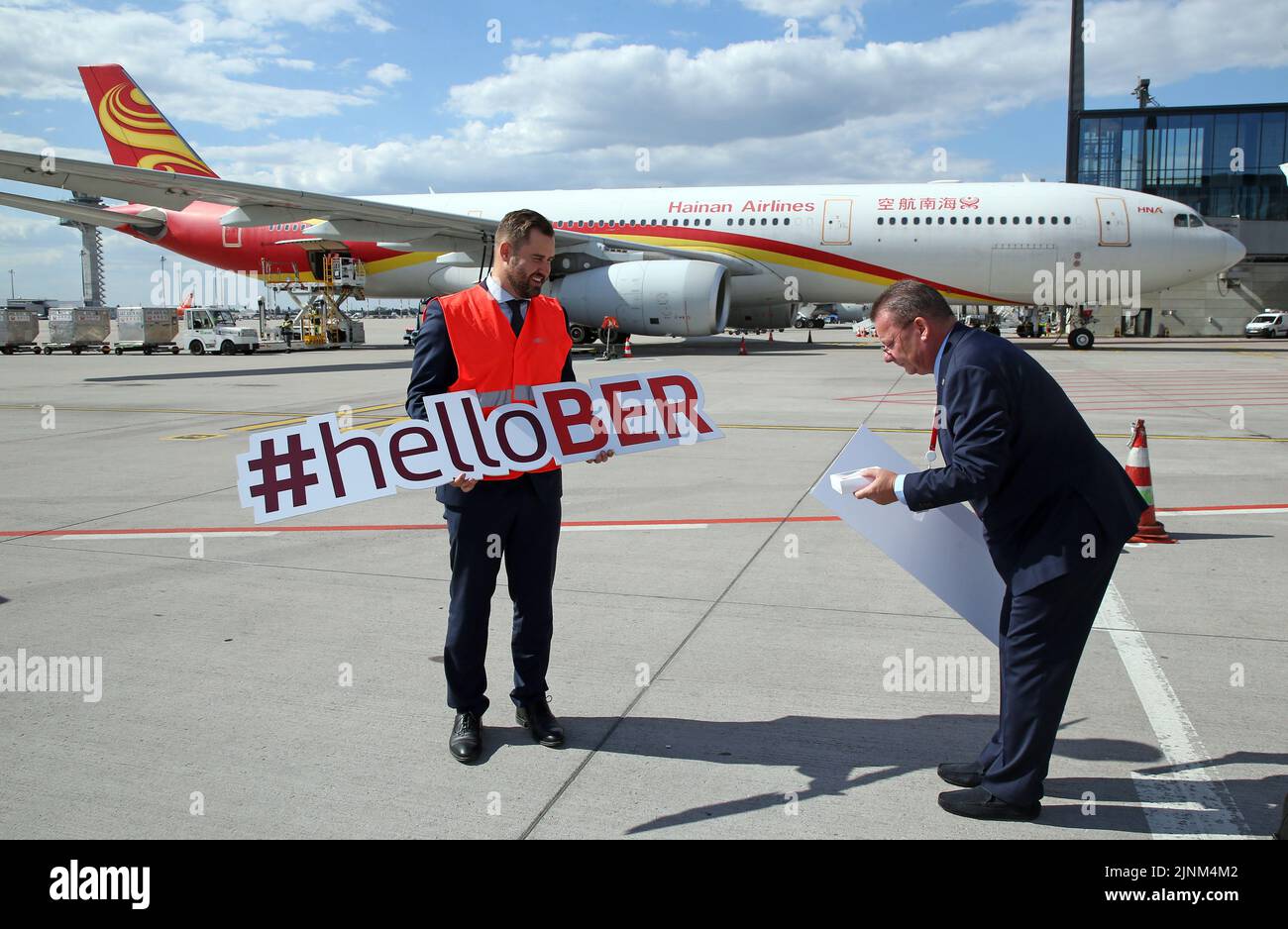 Brandenburg, Germany. 12th Aug, 2022. 12 August 2022, Brandenburg, Schönefeld: Thomas Hoff Andersson (l), COO Berlin Brandenburg Airport, and Stefan Pampel, Account Manager of Hainan Airlines, stand in front of one of the airline's Airbus A330-300 aircraft before the Chinese carrier's maiden flight at Berlin Brandenburg Airport. Photo: Wolfgang Kumm/dpa Credit: dpa picture alliance/Alamy Live News Stock Photo