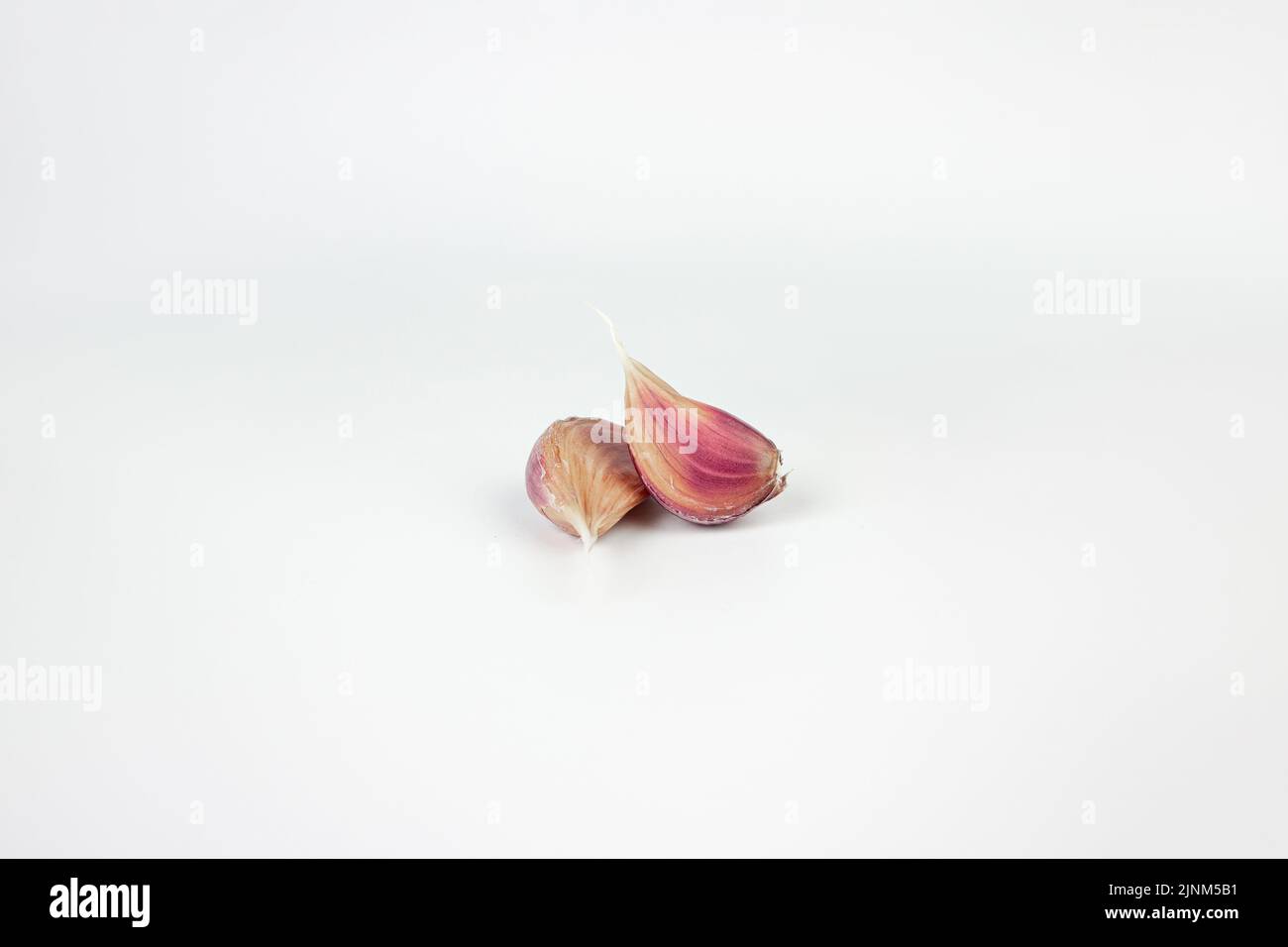 Pieces of garlic clove on white background Stock Photo - Alamy