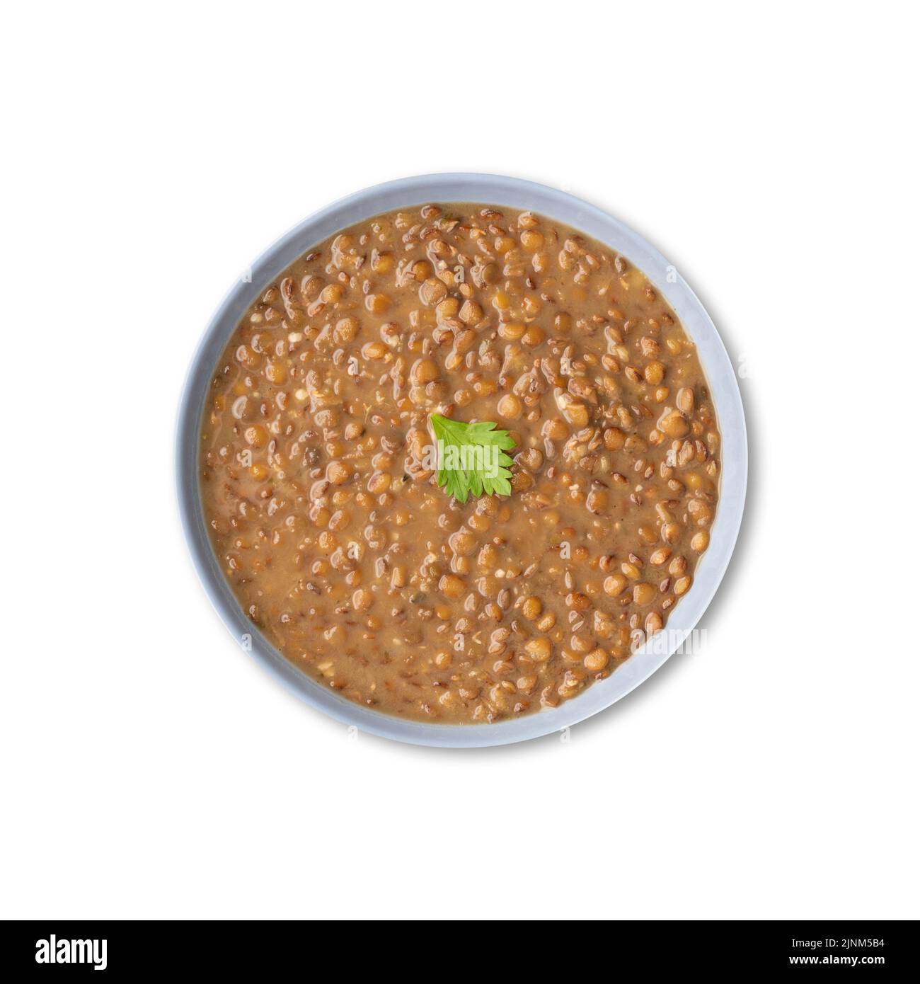 Lentil soup in a bowl isolated over white background. Stock Photo