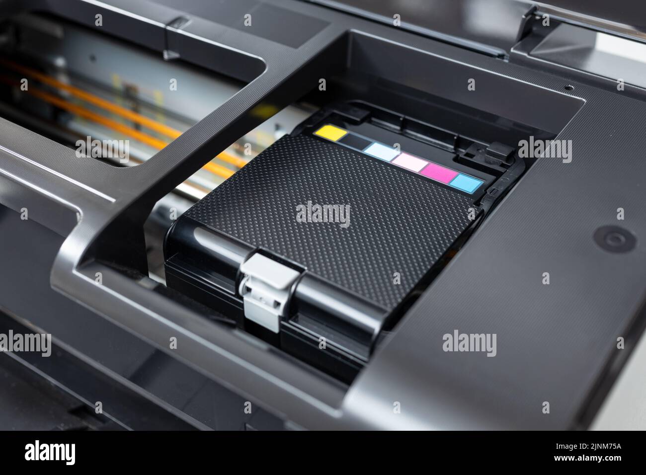 Close up of a multicolor ink cartridges container of a inkjet printer Stock Photo