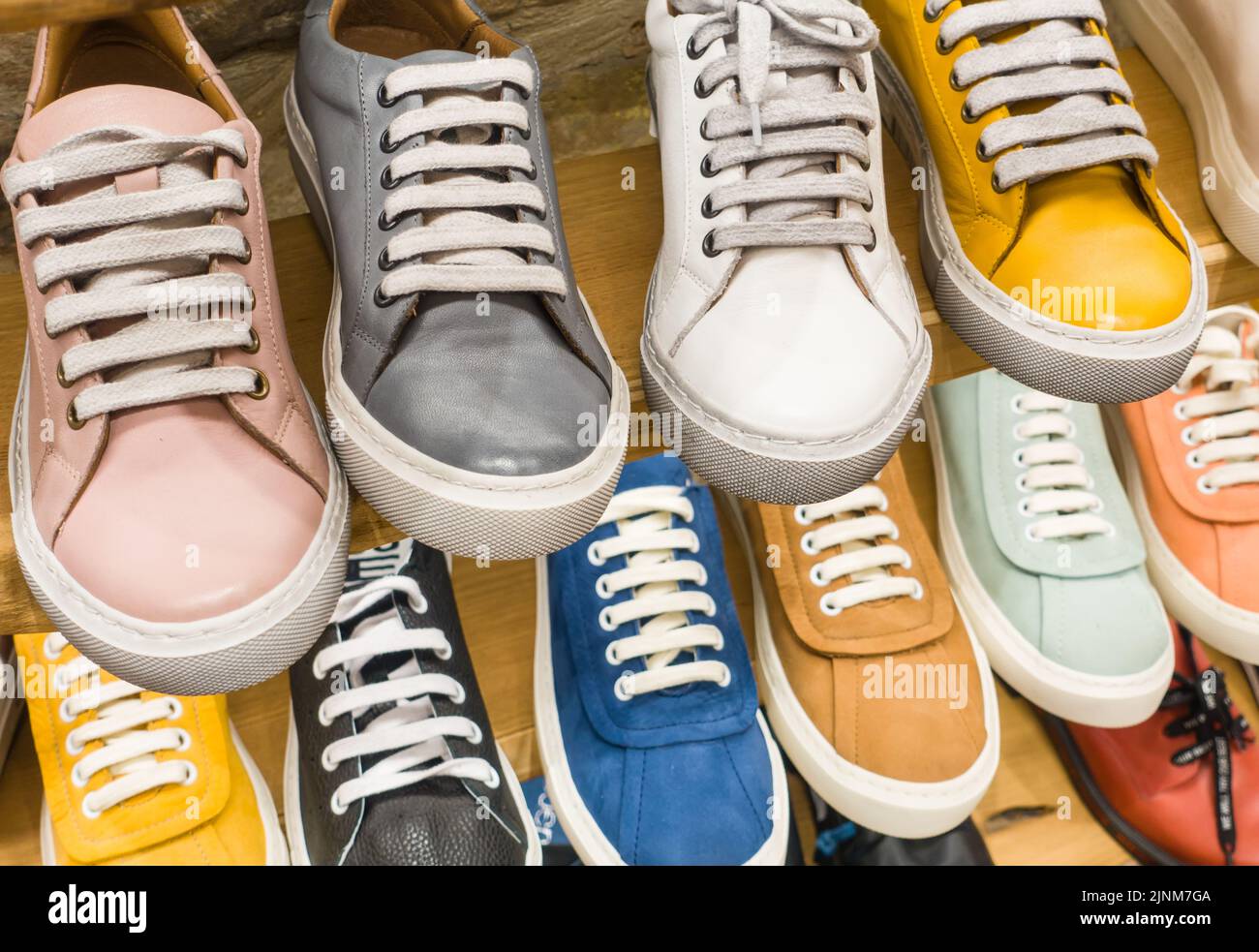 Colorful leather shoes in shop. Variety of the colorful shoes in store. Stock Photo