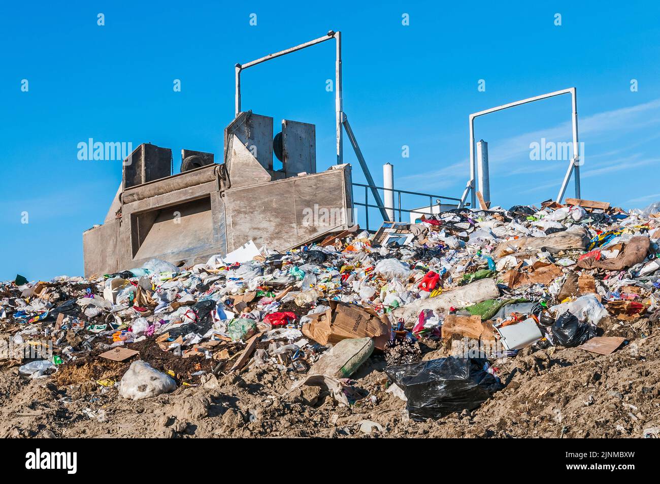 A empty landfill tipper used to tip tractortrailers to dump solid