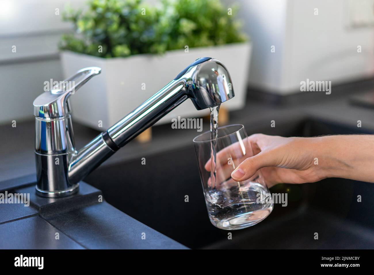 Woman hands filling a glass of tap water Stock Photo Alamy