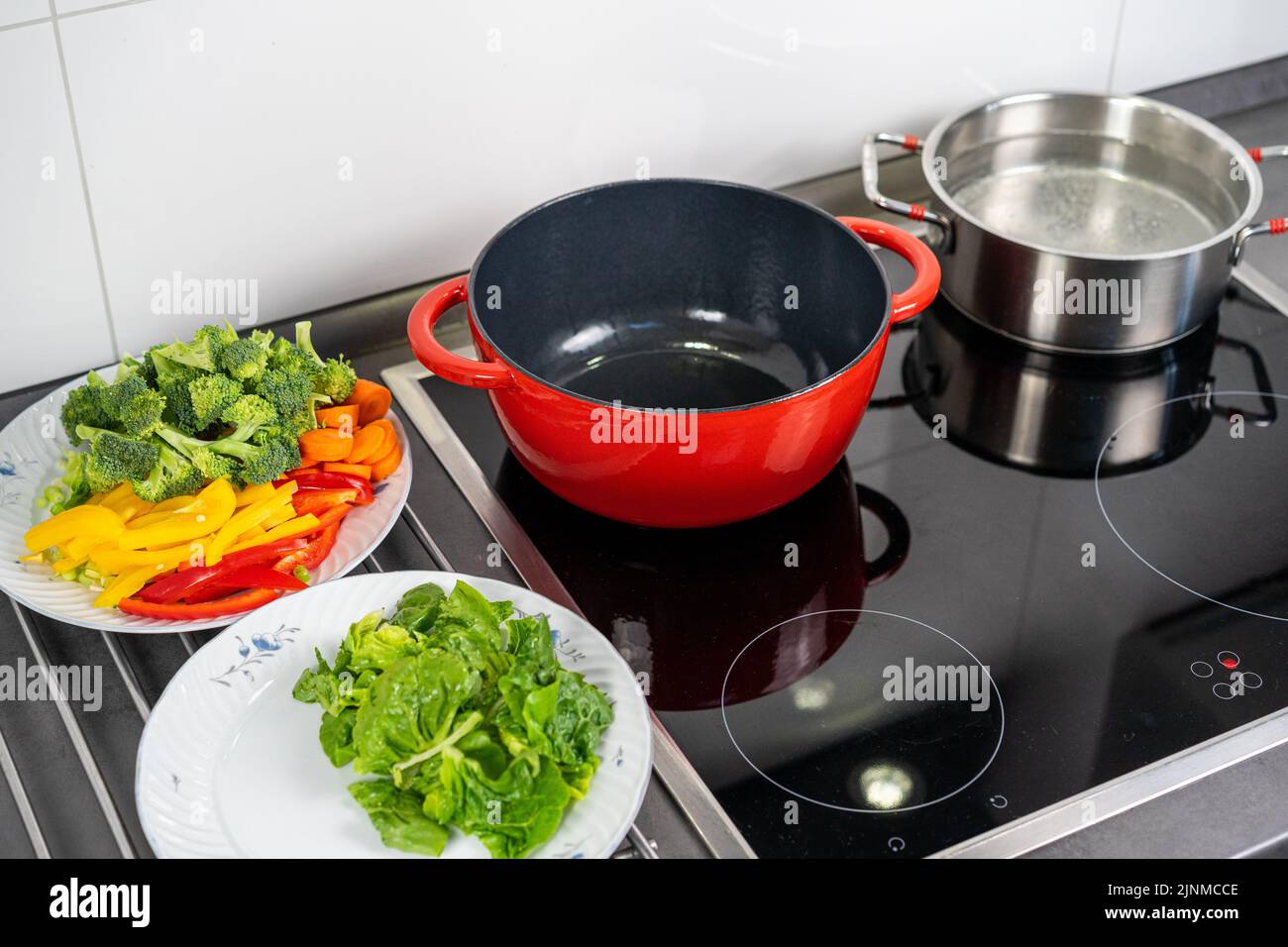 Ready to cook vegetables for pasta in a pan. Modern kitchen Stock Photo