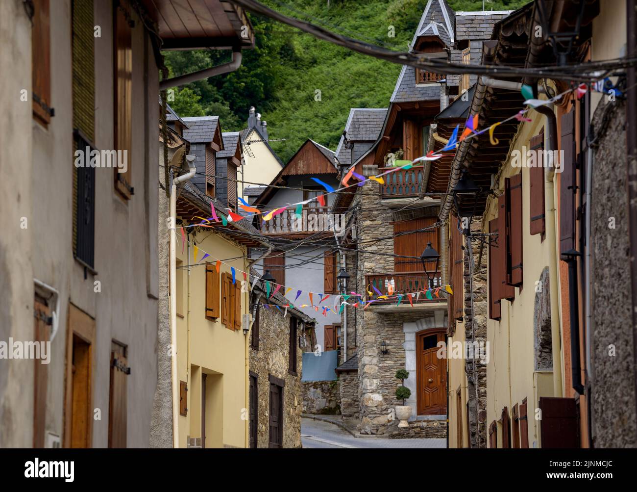 Village of Les decorated for the festival of Sant Joan due to the summer solstice (Aran Valley, Lleida, Catalonia, Spain, Pyrenees) ESP: Pueblo de Les Stock Photo