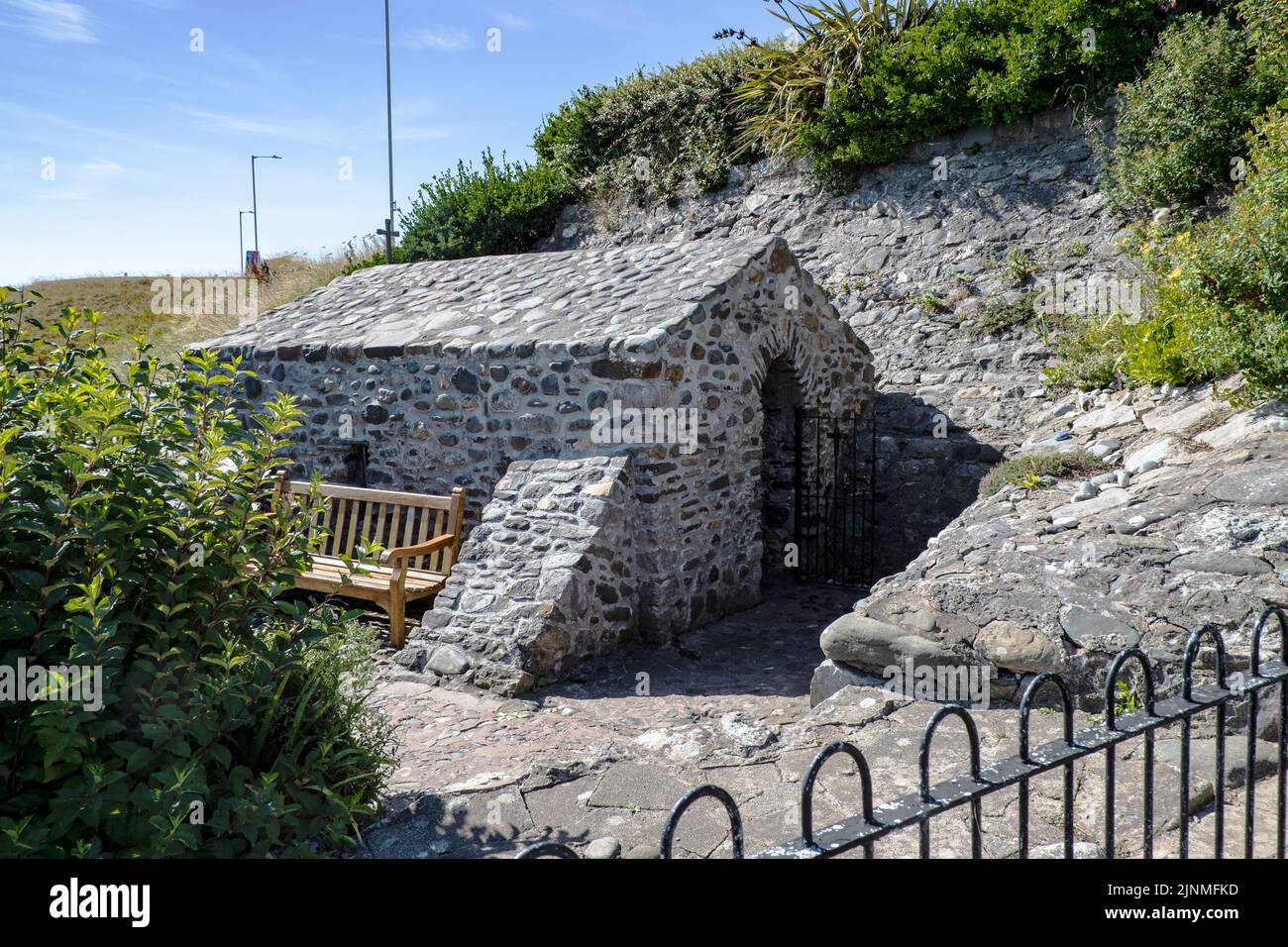 St Trillo's Chapel and The Holy Well, Rhos on Sea, N. Wales is widely considered to be the smallest chapel in Britain, seating a maximum of 6 people. Stock Photo