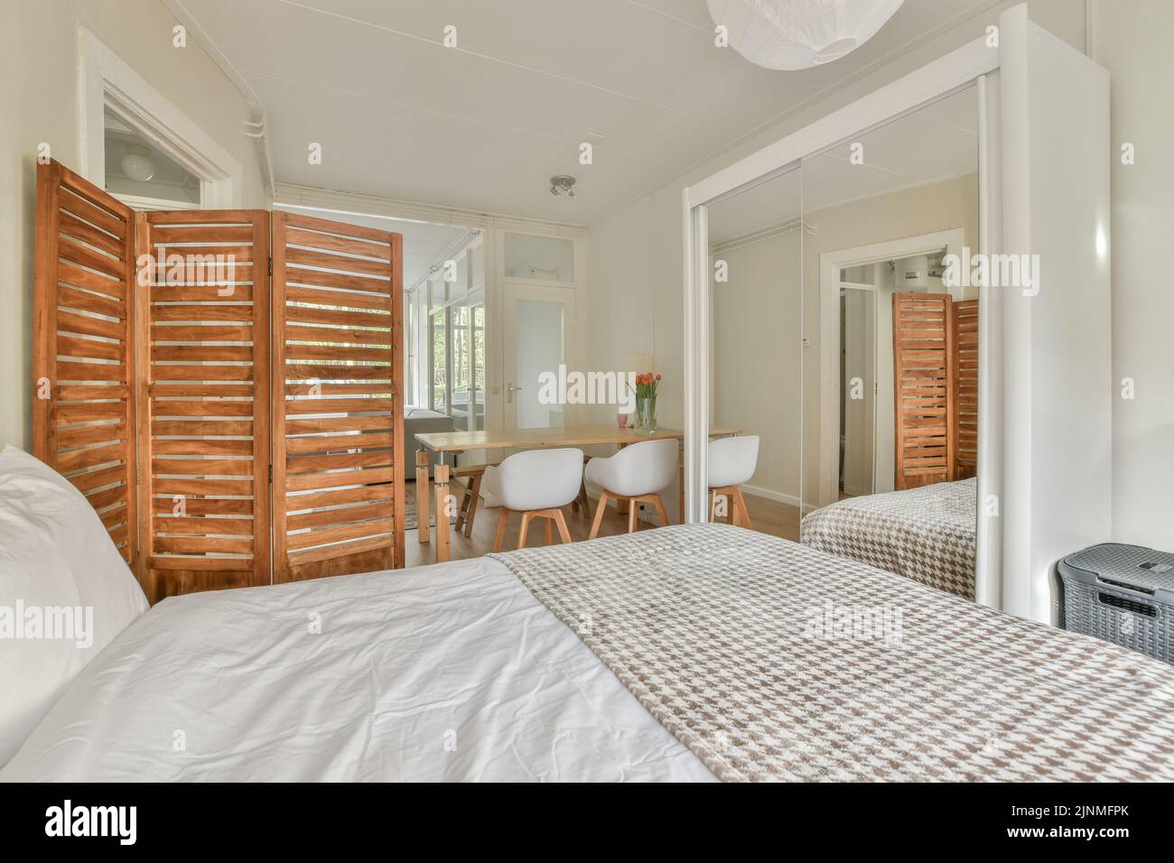Comfortable bed and dining table in spacious bedroom with interior in ... - Mutually Exclusive Dining Table Installation In The Bedroom