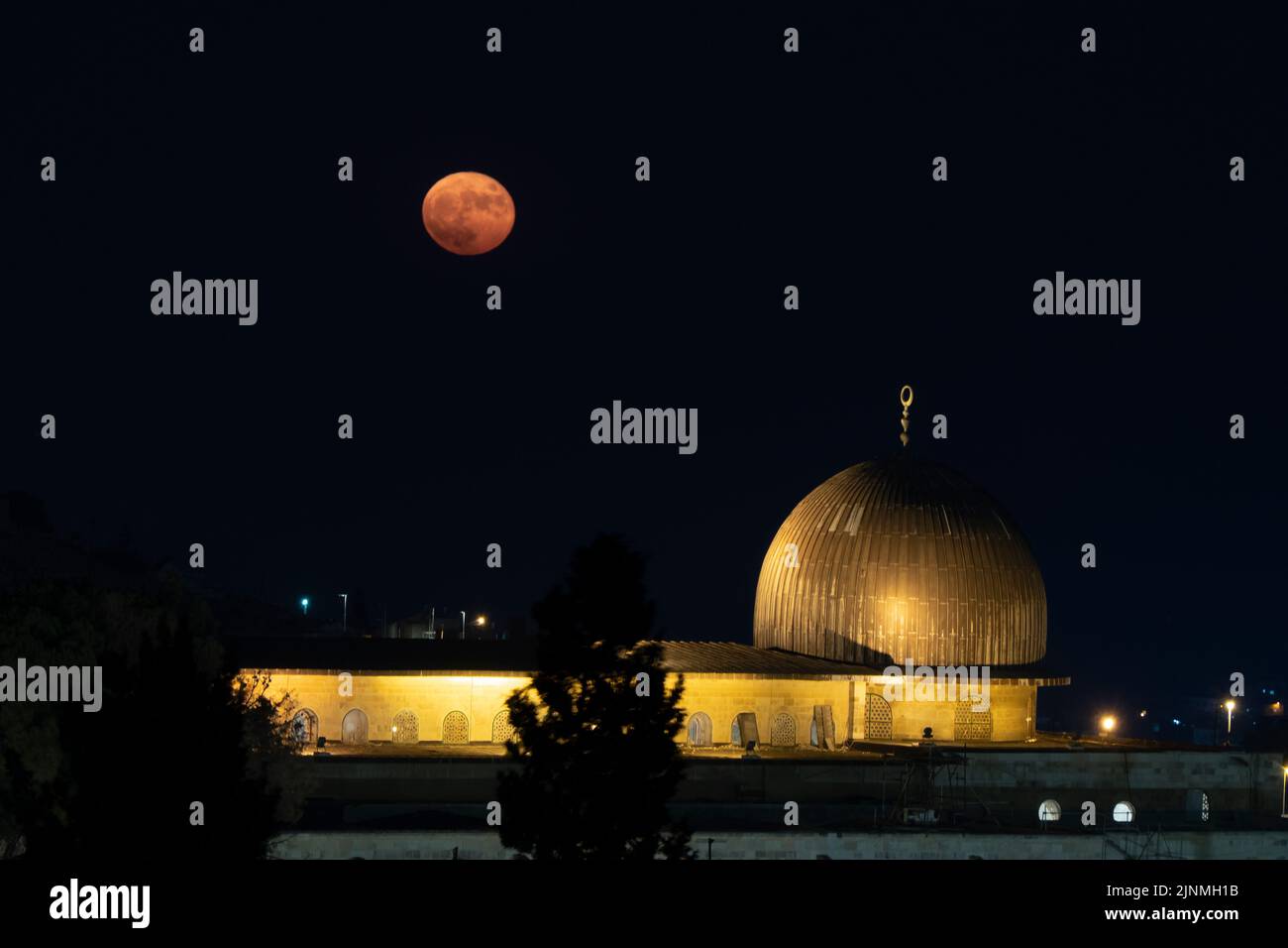Full moon shines over Al-Aqsa Mosque located on the Temple Mount known to Muslims as the Haram esh-Sharif in the Old City East Jerusalem Israel Stock Photo