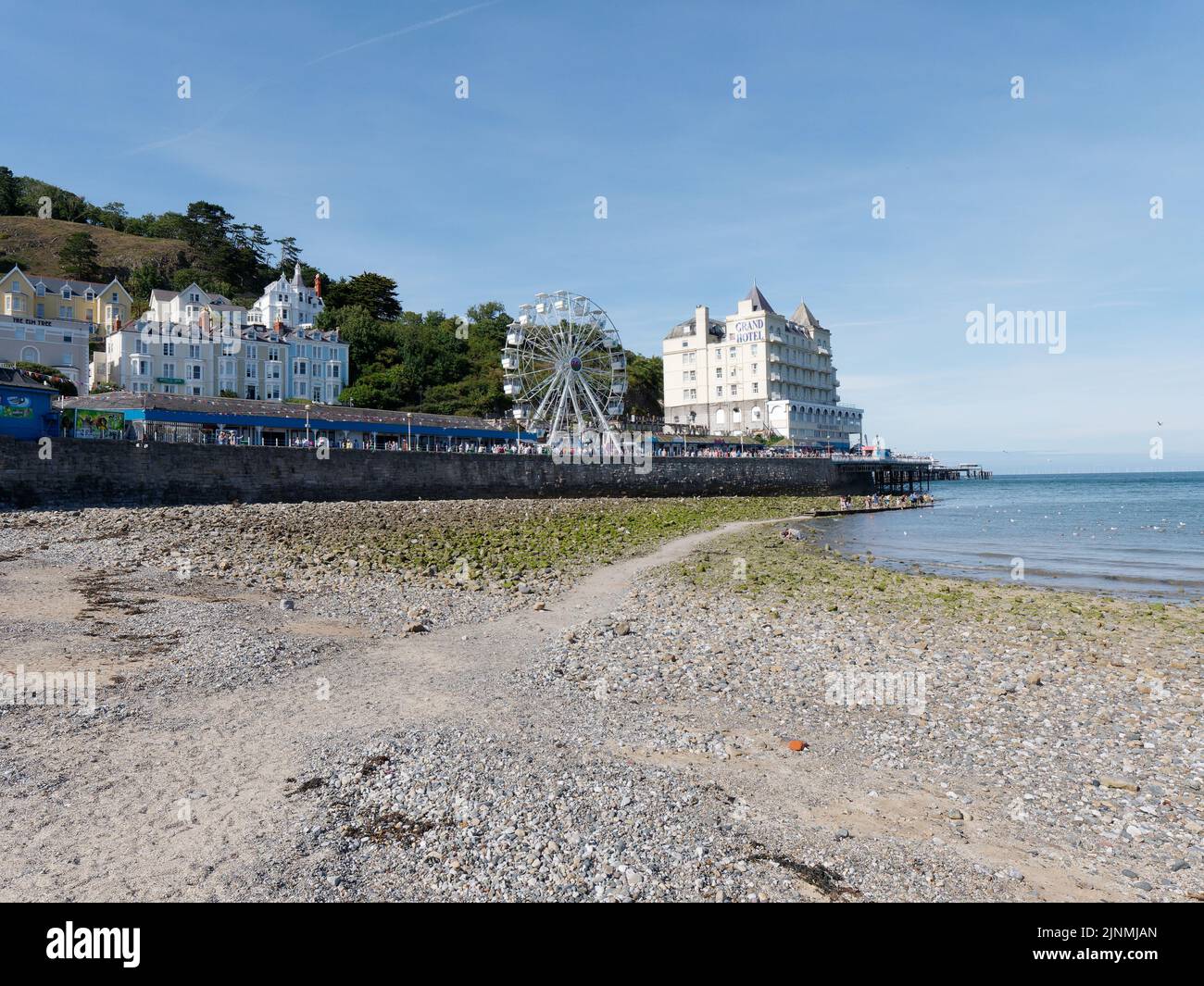 Llandudno, Clwyd, Wales, August 07 2022: Grand Hotel and big wheel as seen from the beach. Stock Photo