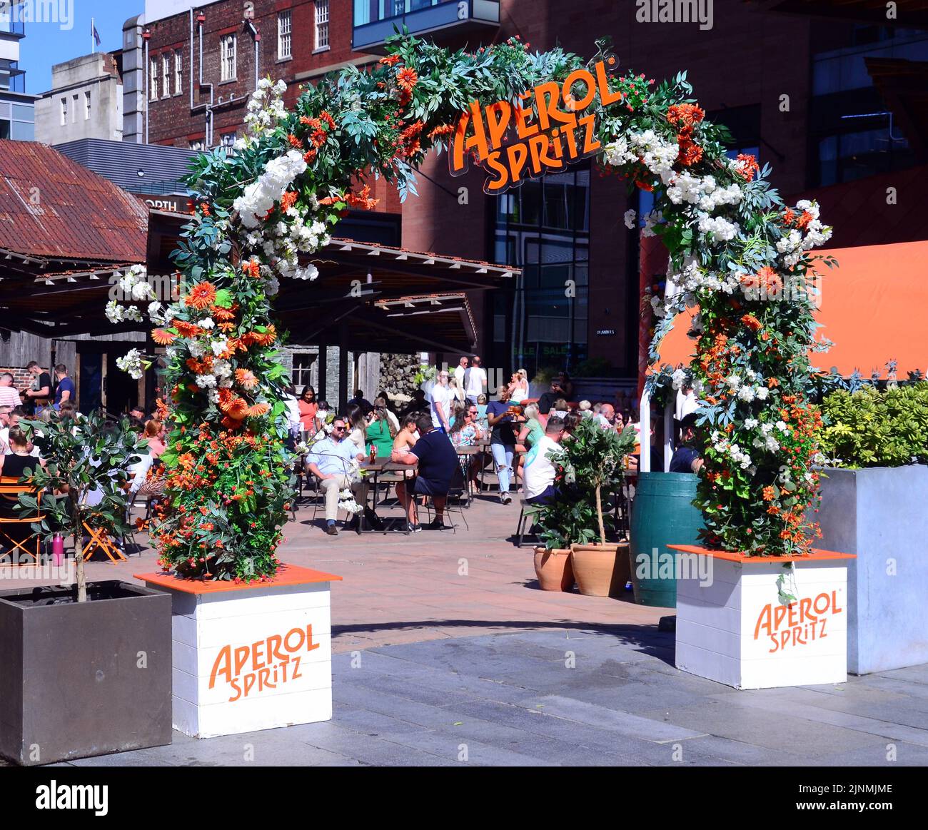 People enjoy a drink at an open air bar in Spinningfields district