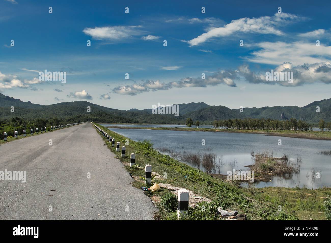 Road along one of the many reservoirs in the mountainous province of Lampang, Thailand, not far from the town of Li. Stock Photo