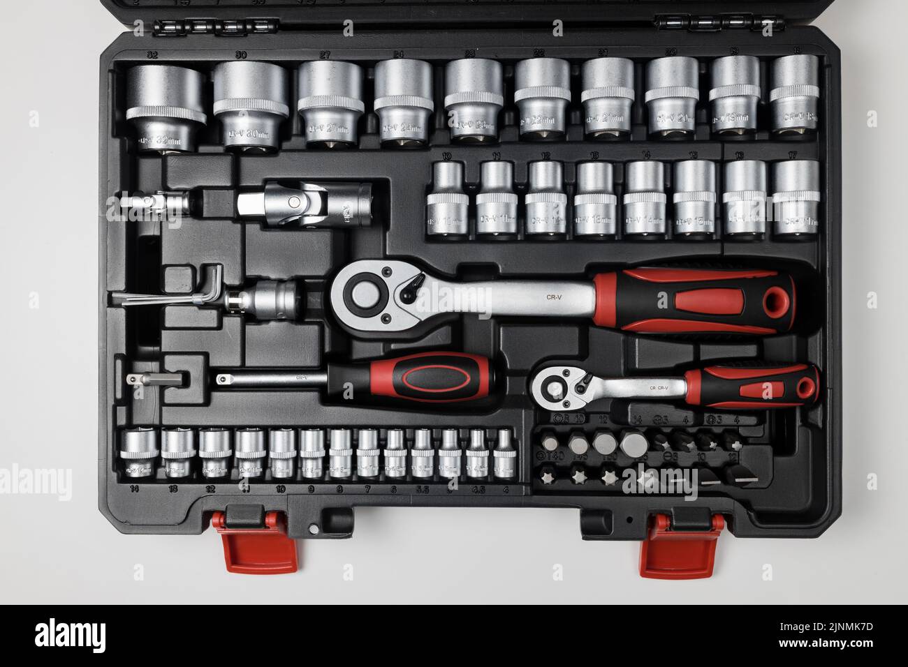 Wrenches of different sizes with different hex heads in a black box on a white table. View from above Stock Photo