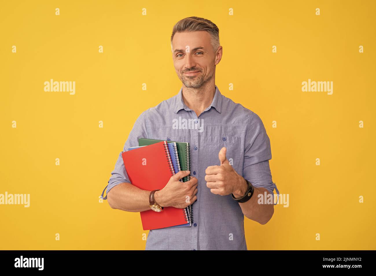 happy man hold school notebook or planner showing thumb up, education Stock Photo
