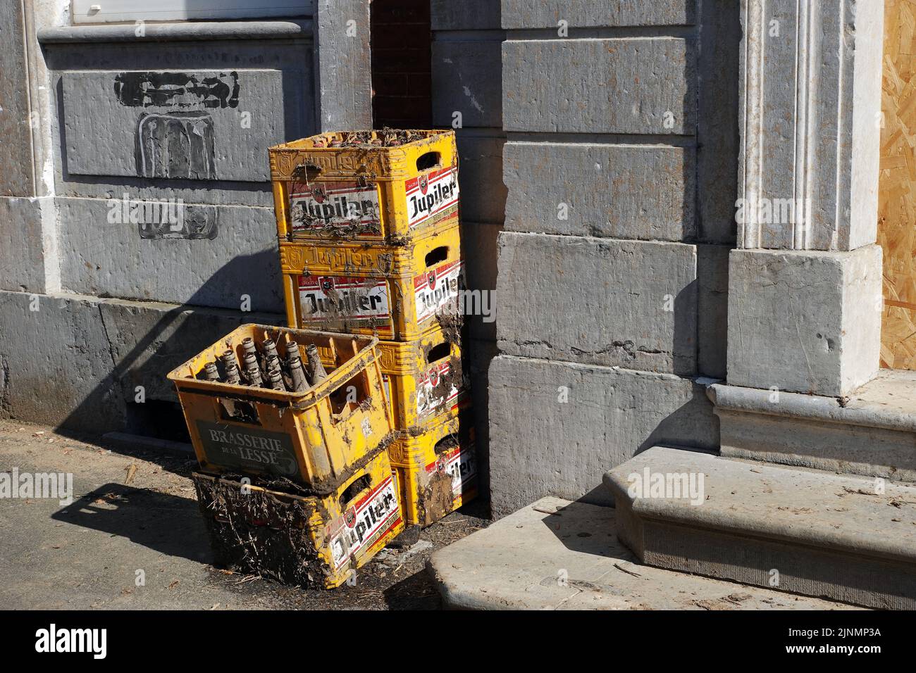 Jupiler beer crates smeared with mud Stock Photo