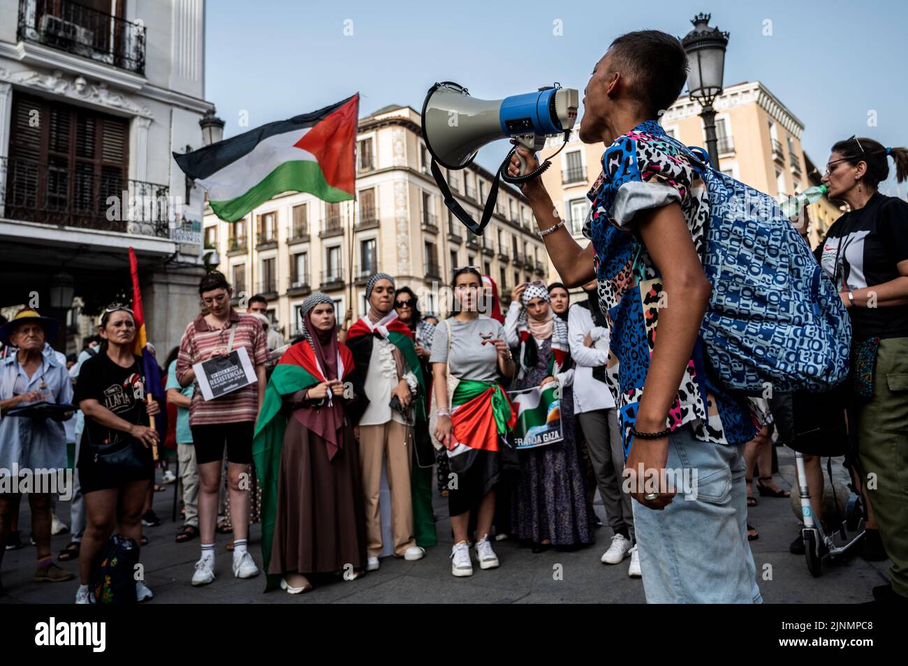 Madrid, Spain. 12th Aug, 2022. Protesters are seen holding placards and Palestine flags during a demonstration where the Palestinian community gathered in front of the Ministry of Foreign Affairs to protest against the recent military offensive on the Gaza Strip by Israel, which has caused the death of 46 people, 16 of them minors. Credit: Marcos del Mazo/Alamy Live News Stock Photo