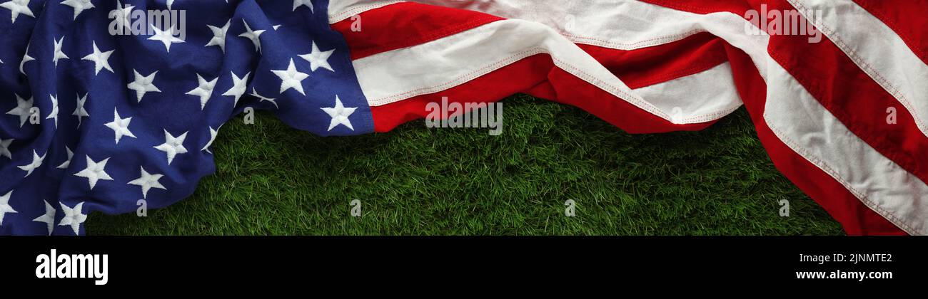 Red, white, and blue American flag on grass for Memorial Day or Veteran's day background Stock Photo