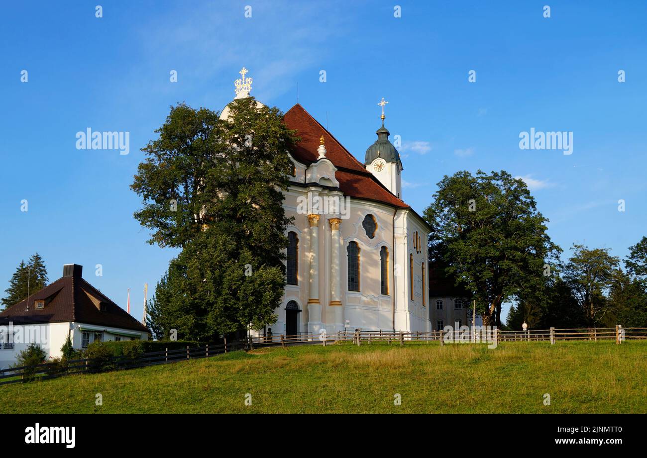 Pilgrimage Church of Wies (Wieskirche) is oval rococo church in Bavarian Alps on sunny summer day (Steingaden, Weilheim-Schongau, Bavaria, Germany) Stock Photo