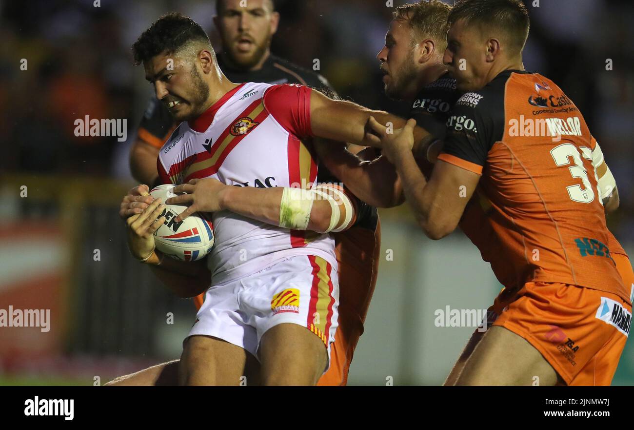 Catalans Dragons' Mathieu Cozza is tackled during the Betfred Super League match at The Mend-A-Hose Jungle, Castleford. Picture date: Friday August 12, 2022. Stock Photo