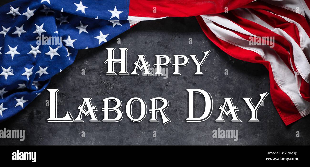 US American flag on worn black background. For USA Labor day celebration. With Happy Labor Day text. Stock Photo