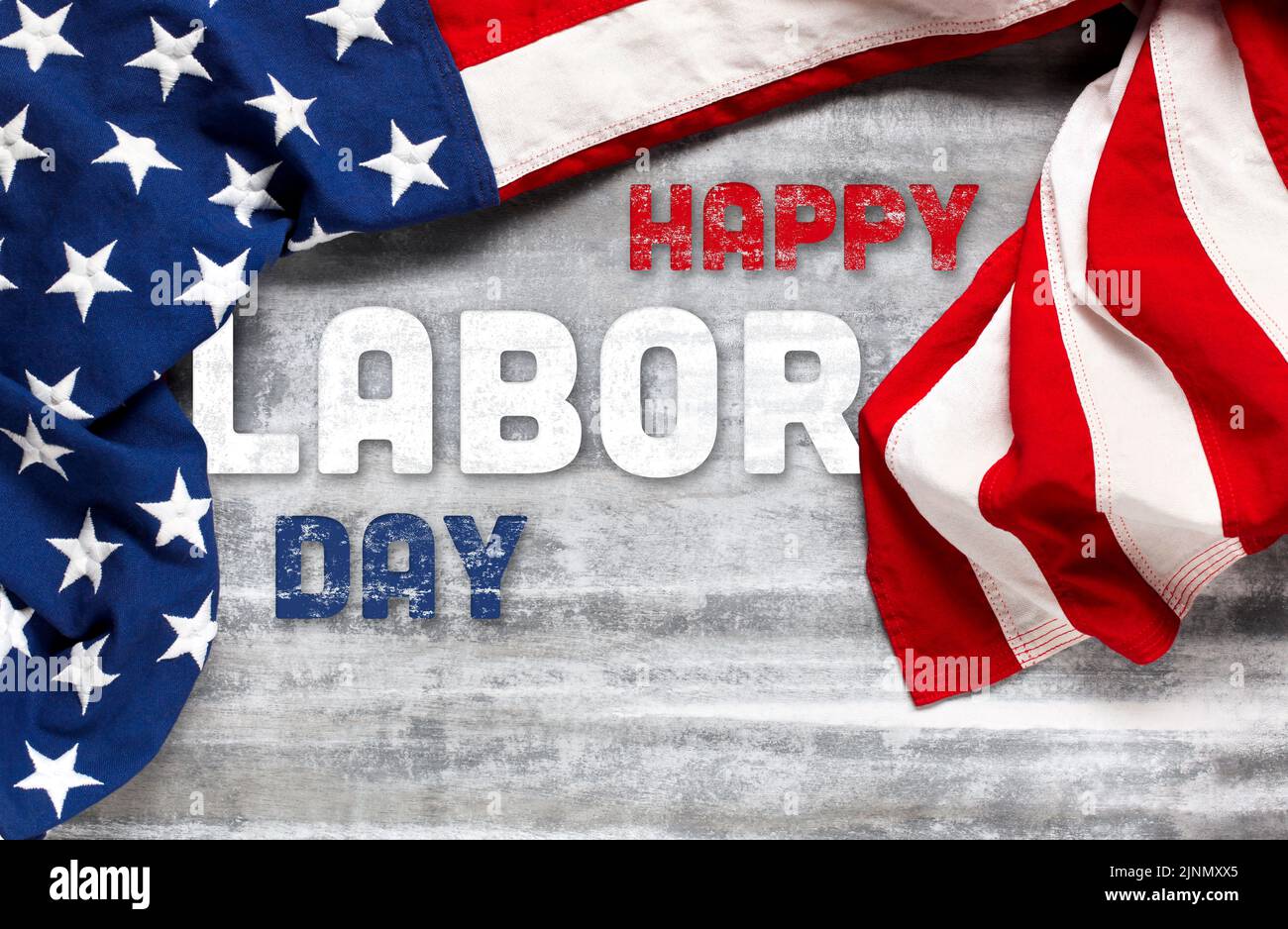 US American flag on worn white wooden background. For USA Labor day celebration. With Happy Labor Day text. Stock Photo