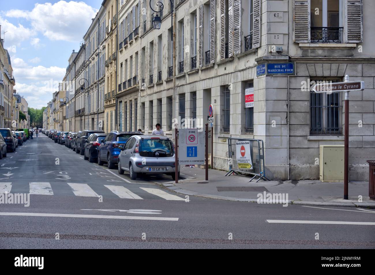 Versailles, France - May 28, 2022: Typical French street with old residential buildings in poor decorative order and some motion blurring Stock Photo