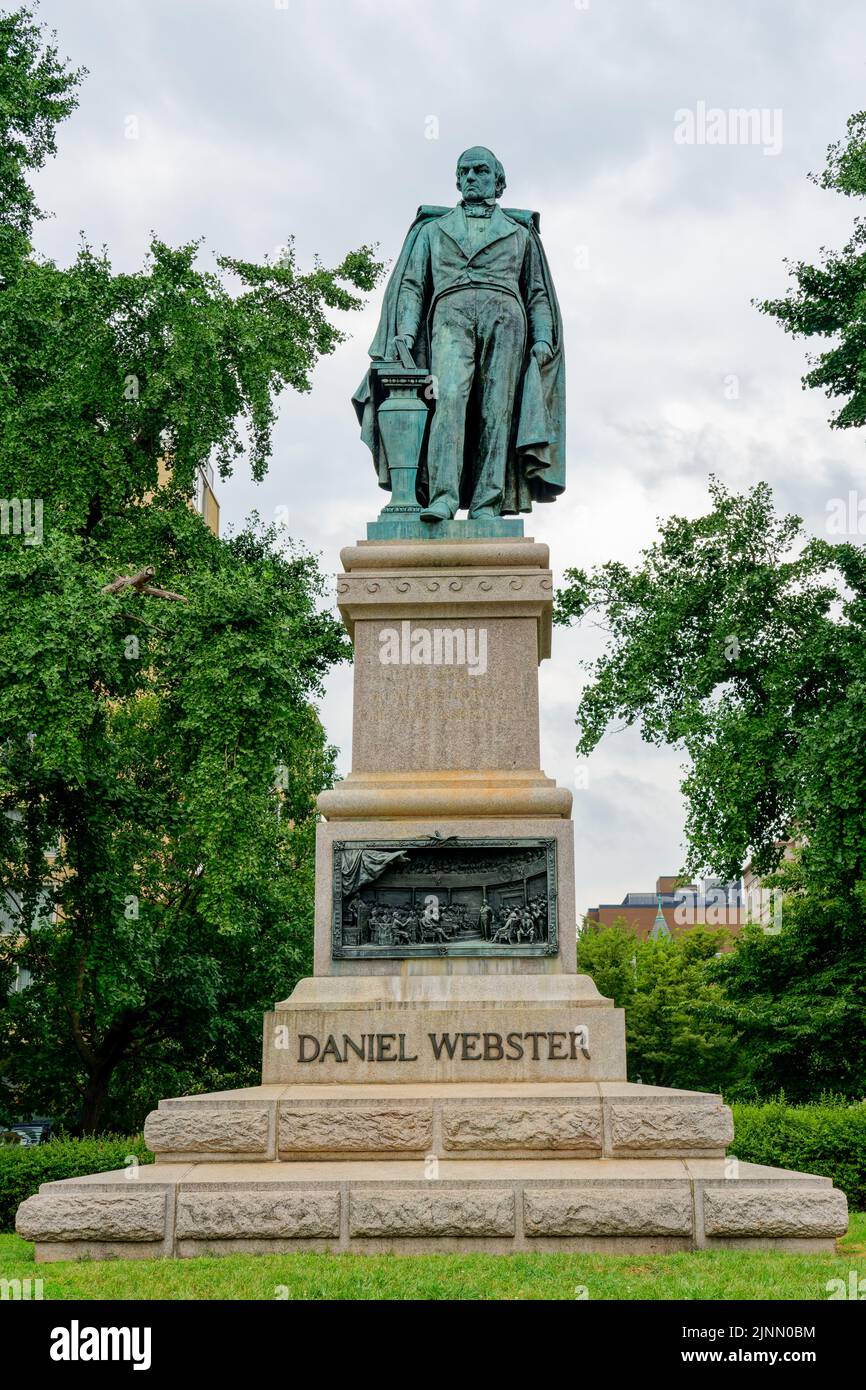 Daniel Webster memorial includes a statue sculpted in 1898 by Gaetano Trentanove. The pedestal dedicated in 1900 includes bronze bas-relief panels. Stock Photo