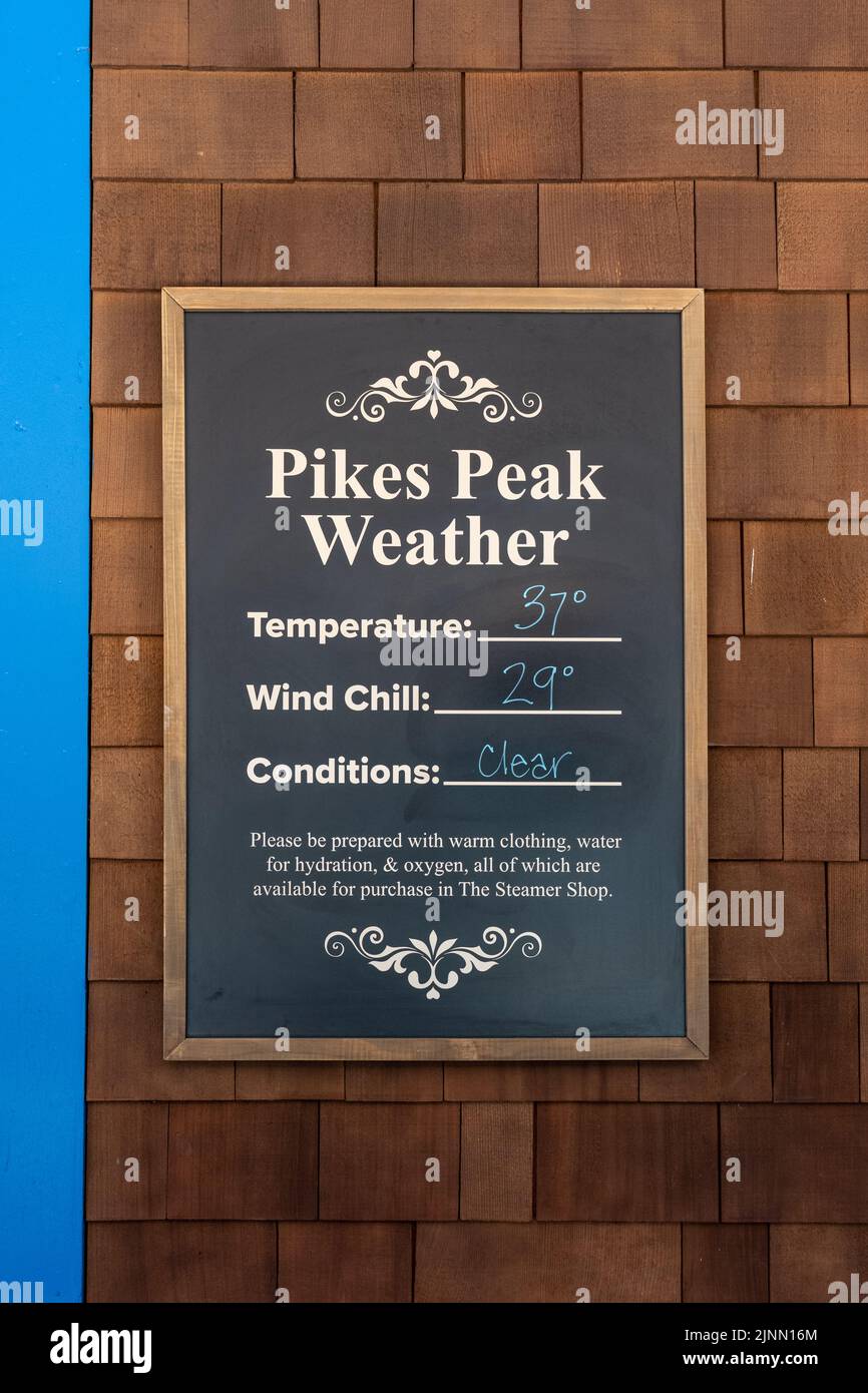 sign at the cog railway station for weather at the top of Pike's Peak with temperature, wind chill and conditions with suggestions for how to prepare Stock Photo