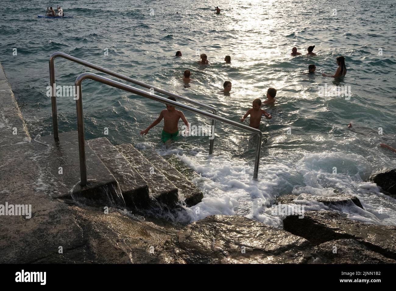 Kids swimming in Piran on the slovenian coast Stock Photo