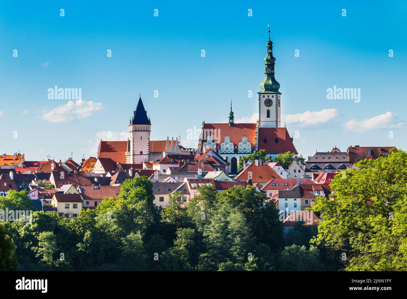 View to scenic historical center of Tabor old town with towers, red rooftops or blue sky. Gothic church with renaissance gables - Czech cultural sight. Stock Photo