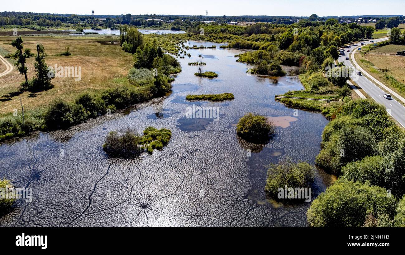 Belgium. 12th Aug, 2022. Aerial drone picture shows Illustration picture shows the 'L'Etang de l'Ile' in Virton Luxembourg province, Belgium, on Friday 12 August 2022. Severe droughts are effecting Europe since the beginning of the year. Weather forecast services announced an 8 to 10 day long heat wave. BELGA PHOTO BRUNO FAHY Credit: Belga News Agency/Alamy Live News Stock Photo