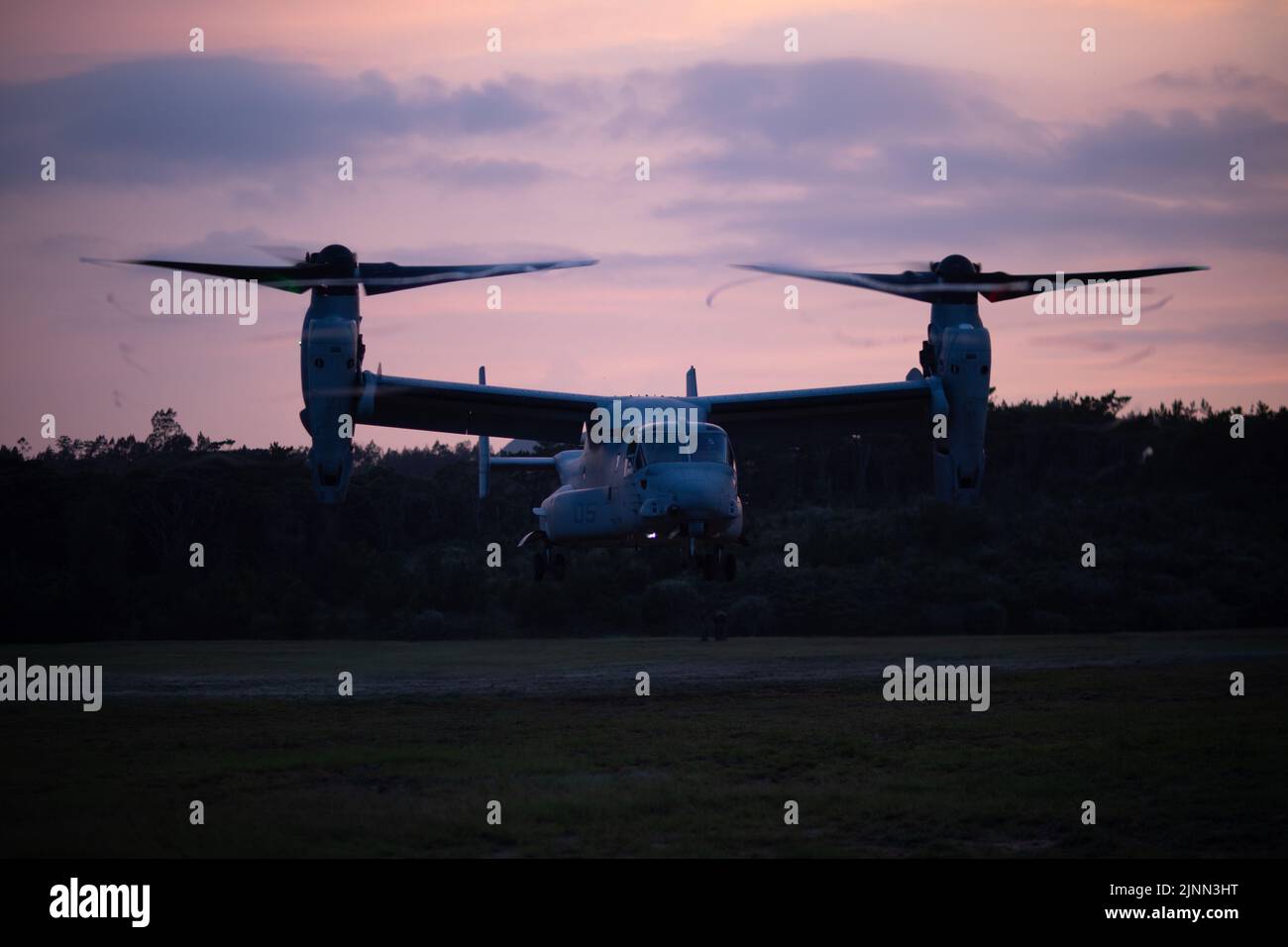 U.S. Marines with Marine Wing Support Squadron (MWSS) 171 take off in an MV-22B Osprey assigned to Marine Medium Tiltrotor Squadron (VMM) 265 during a Fast Rope Masters Course (FRMC) at Landing Zone Sterling, Okinawa, Japan, July 26, 2022. Fast roping allows Marines to enter landing zones that are too dangerous for helicopters to safely land. Fast Rope and Helicopter Rope Suspension Training teaches Marines proper knots and rappelling techniques, and builds confidence for maneuvering from air to ground. (U.S. Marine Corps photo by Pfc. Justin J. Marty) Stock Photo