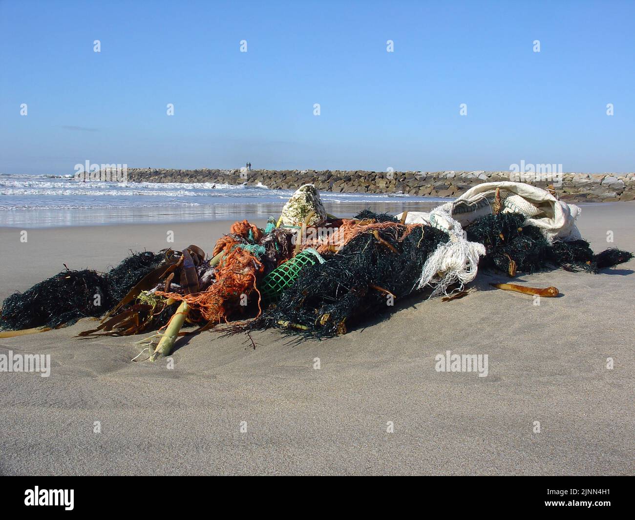 Ocean pollution caused by human activities, plastics and fishnets. Clean the ocean and save the marine species from injuries. Nets and plastics. Stock Photo