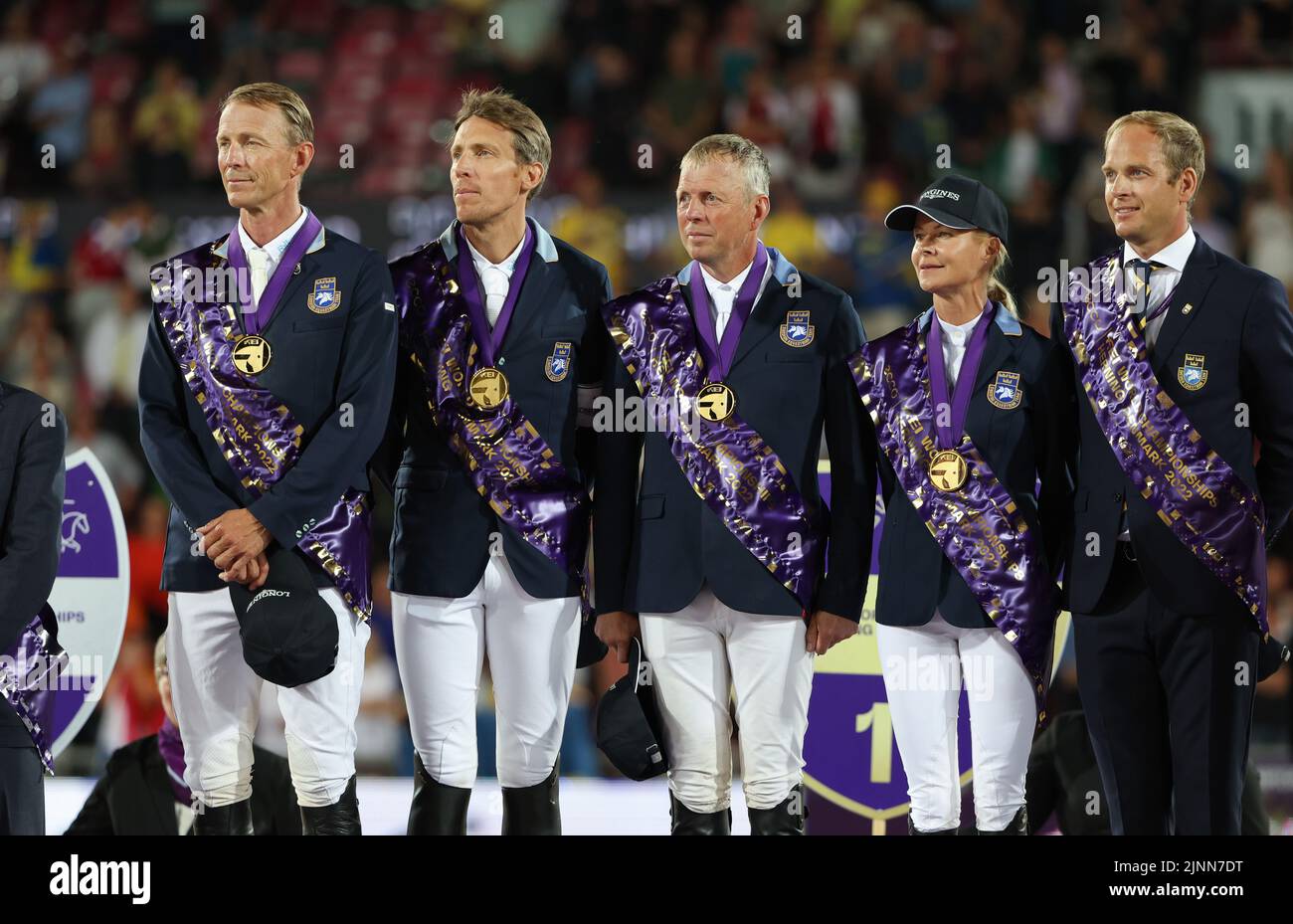Herning, Denmark. 12th Aug, 2022. Equestrian sport; World Championship, Show Jumping. Show jumpers Peder Fredricson (l-r), Henrik von Eckermann, Jens Fredricson, Malin Baryard-Johnsson and Chef d'Equipe Henrik Ankarcrona (Sweden) stand on the podium with gold medals at the award ceremony. Credit: Friso Gentsch/dpa/Alamy Live News Stock Photo