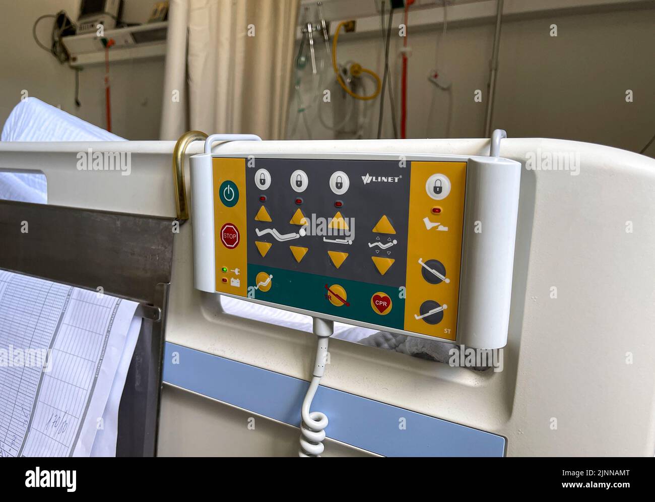 Modern medical bed with lifting mechanism on the control panel in the