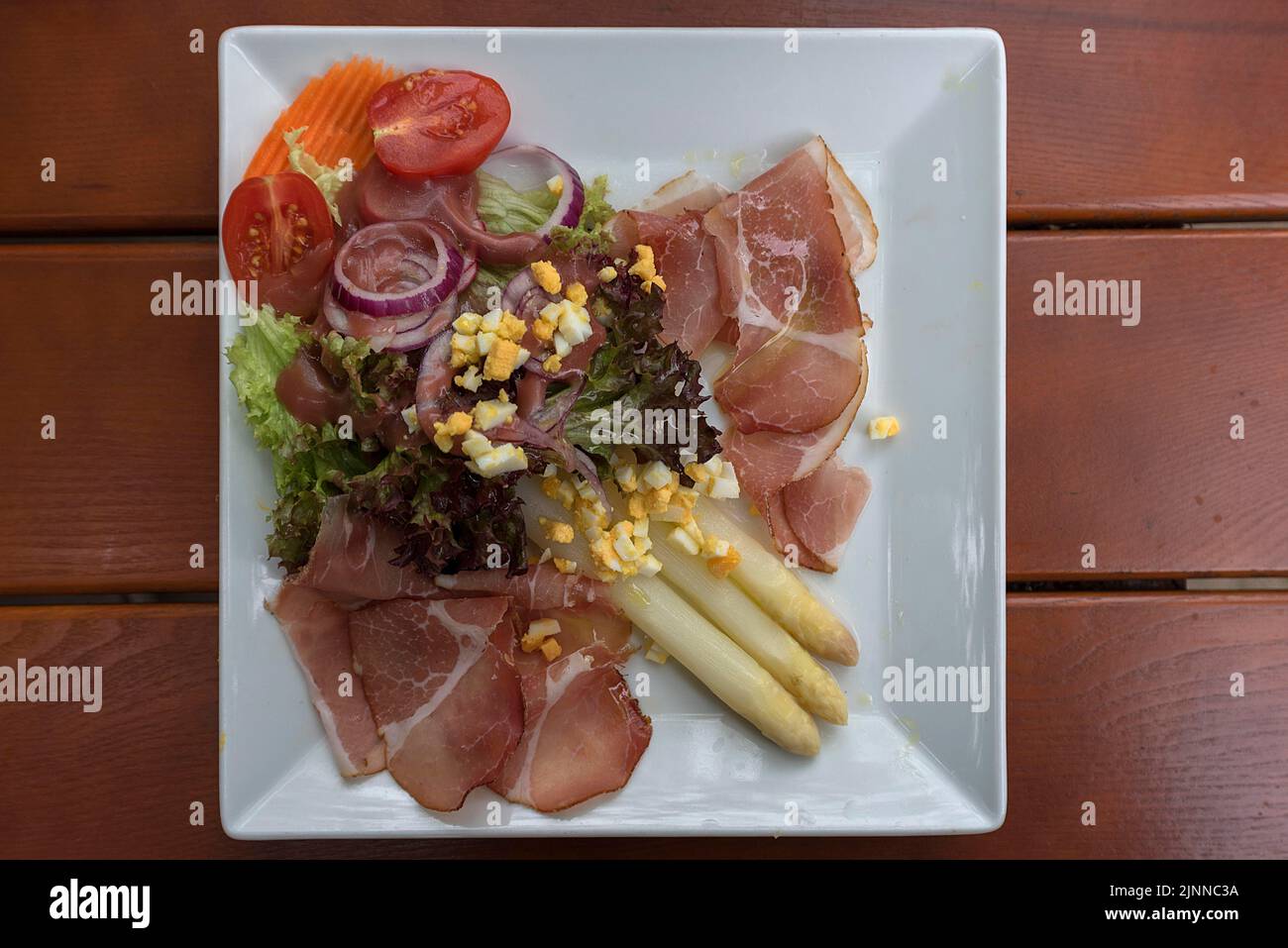 Asparagus salad with raw ham, Bavaria, Germany Stock Photo