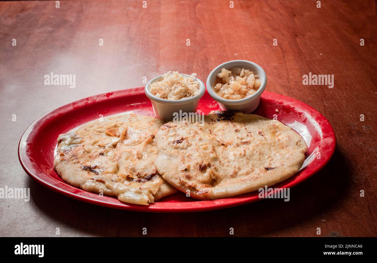 Traditional pupusas served on a wooden table, Closeup of Nicaraguan pupusas served on wooden table. Delicious traditional Salvadoran Pupusas with Stock Photo