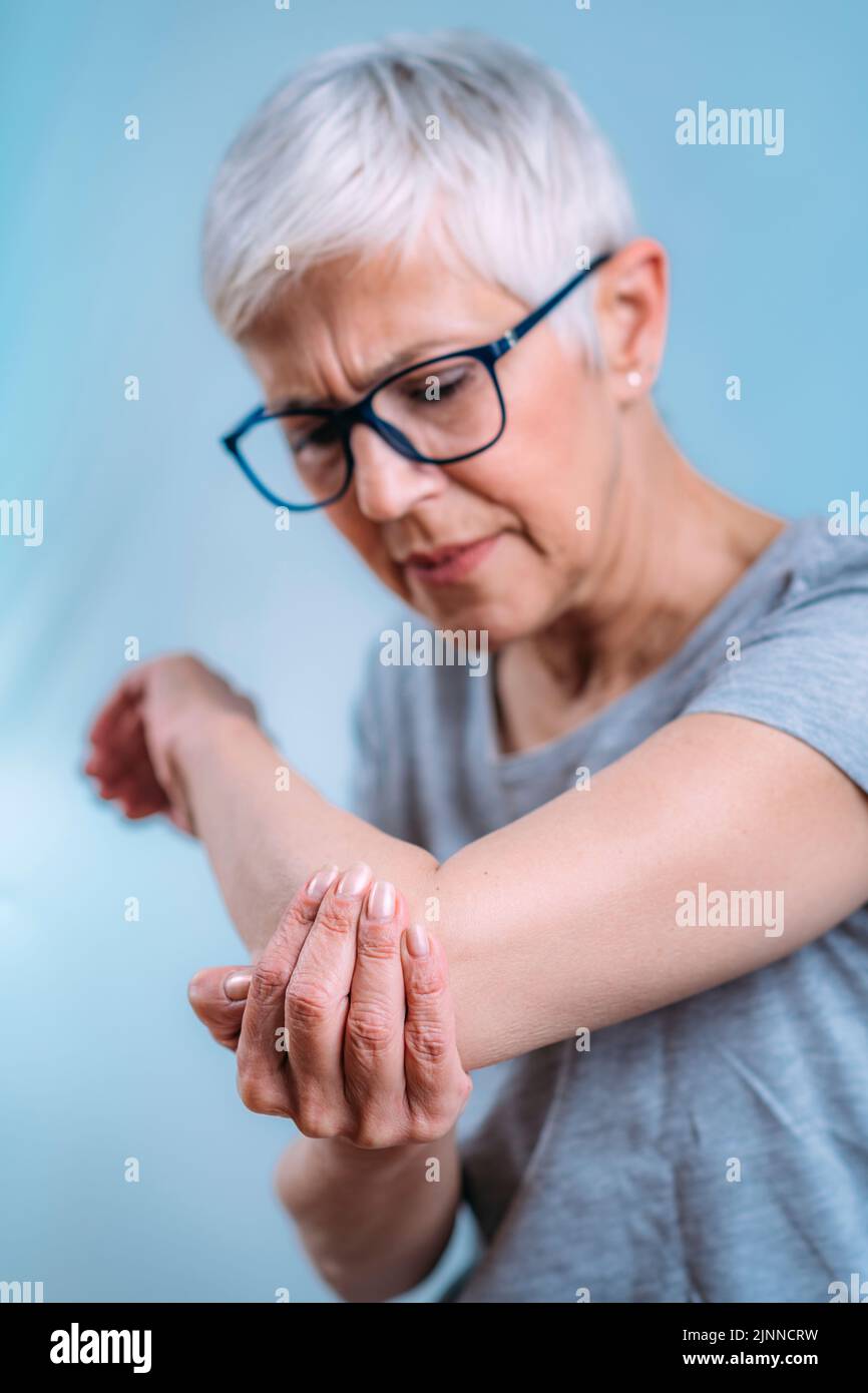 Senior woman with painful elbow Stock Photo