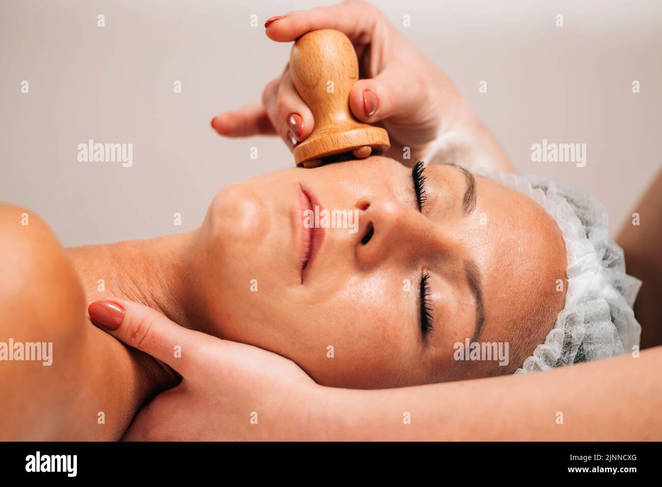 Maderotherapy face massage Stock Photo