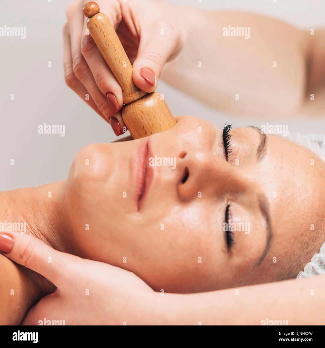 Maderotherapy face massage Stock Photo