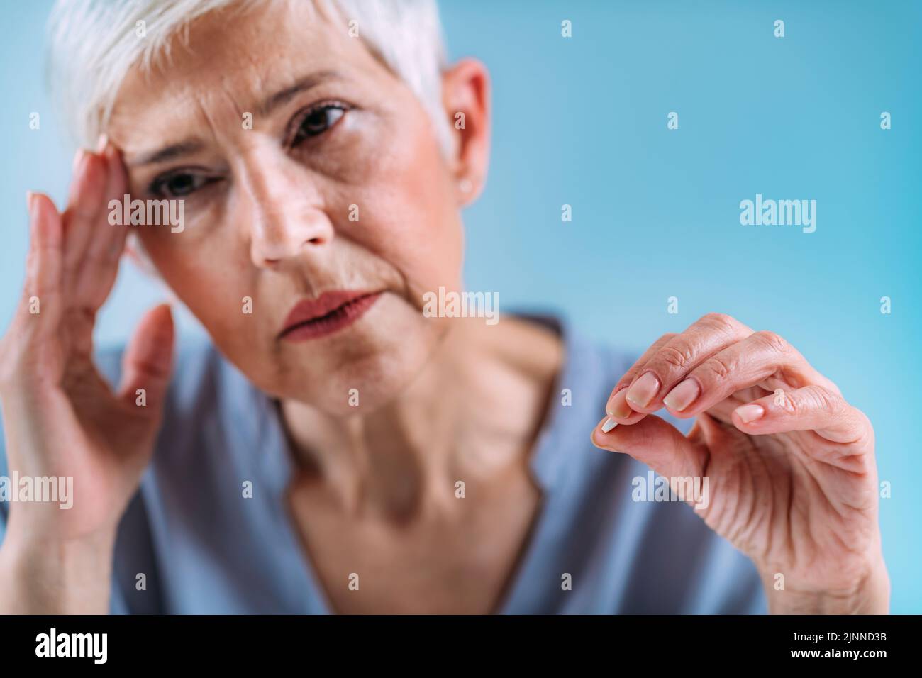 Senior woman with headache Stock Photo