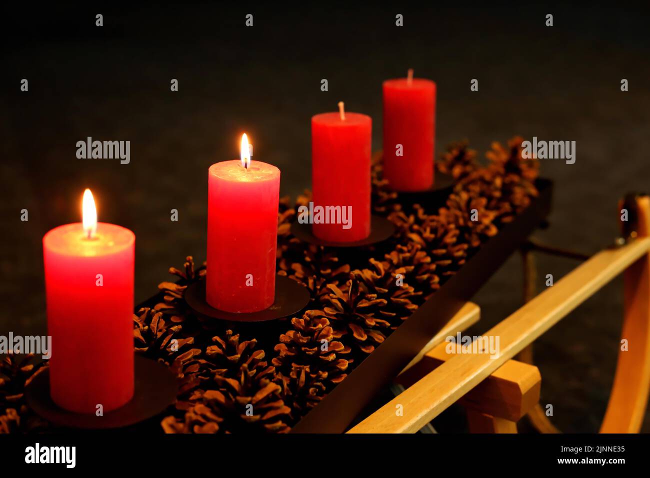 Four Advent candles decorated with pine cones on a sleigh, Second