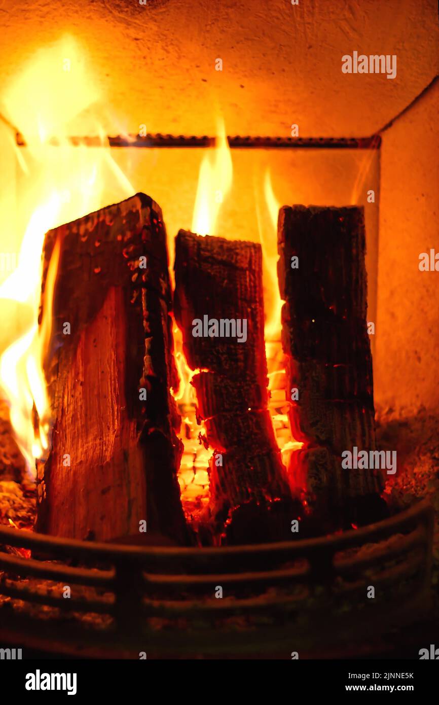 Cosy stove fire with burning logs Stock Photo Alamy