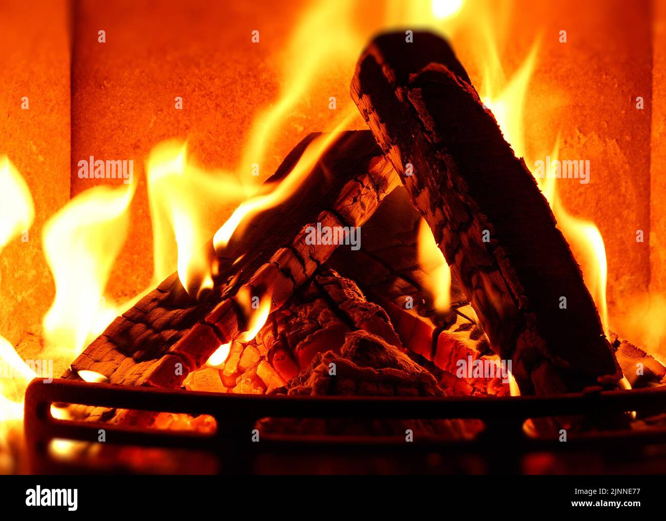 Cosy stove fire with burning logs Stock Photo Alamy