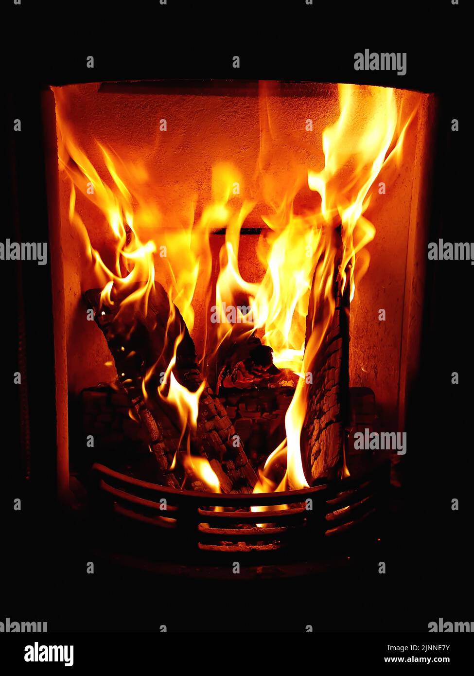 Cosy stove fire with burning logs Stock Photo Alamy
