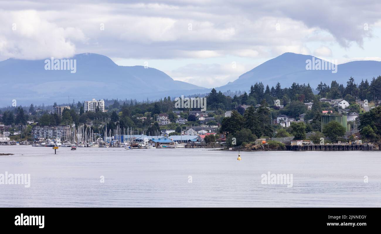 City by the water, Marina with Boats, surrounded by Homes, mountains