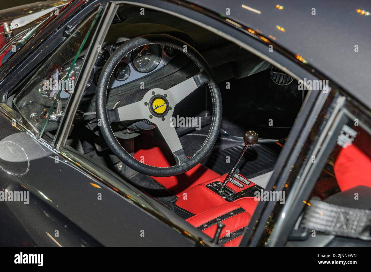 View into interior of Ferrari Dino from 60s 70s with steering wheel and lever of manual gear shift, fair Techno Classica, Essen, North Stock Photo