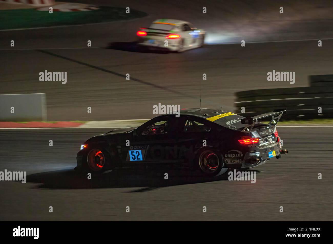 Race car BMW M4 at night during car race 24-hour race 24h race on Grand Prix track of Nuerburgring race track with glowing brake discs, Nuerburgring Stock Photo
