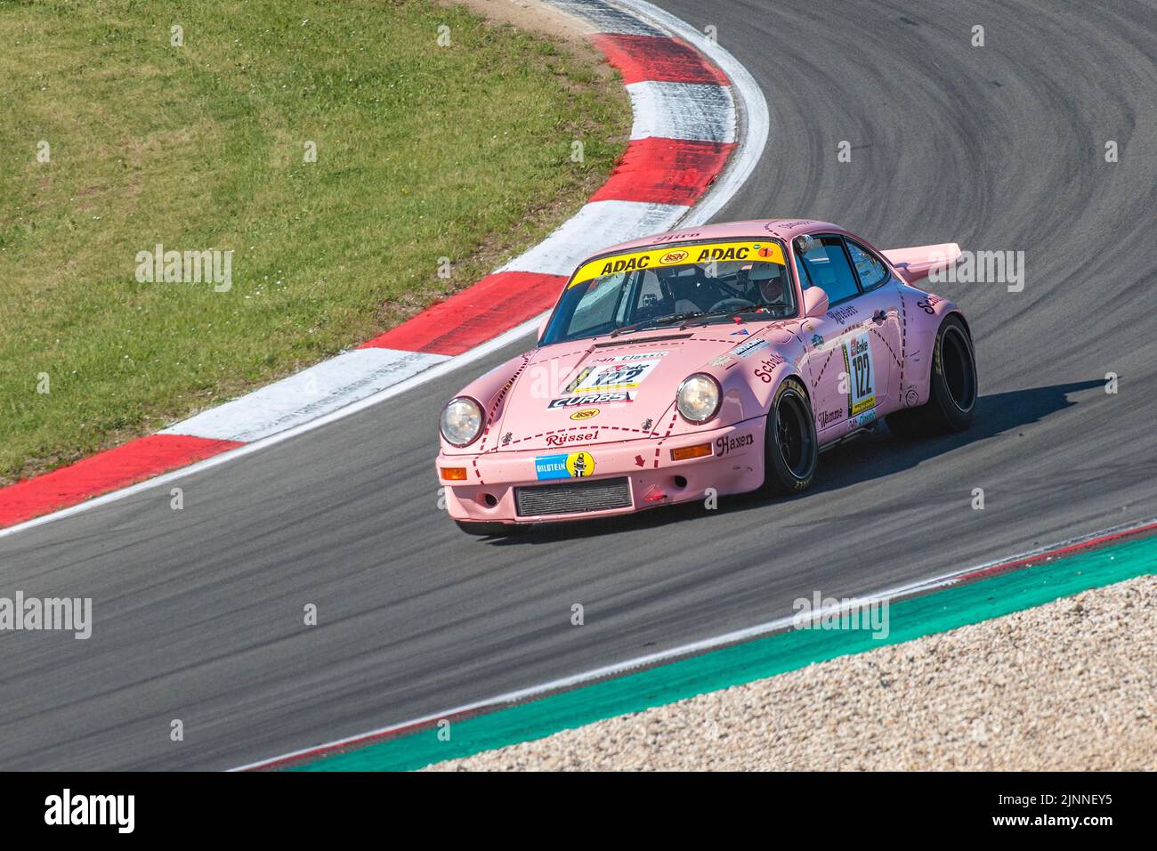 Historic racing car Porsche 911 Carrera RS with historic design paint Sau at car racing for oldtimer youngtimer classic cars 24-hour race 24h race Stock Photo
