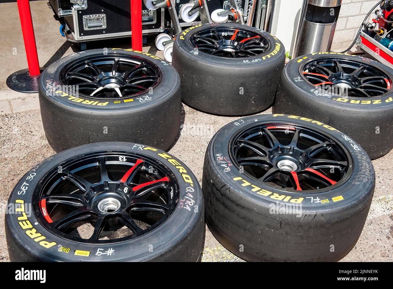 Used Pirelli racing tyres slicks on rim with central lock lie on ground